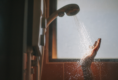 person feeling hot shower water in evening