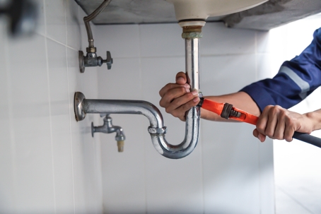 Plumber working in the bathroom, plumbing repair service